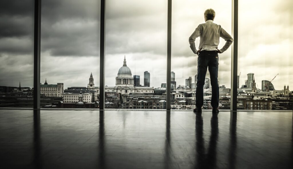 a person watching the view over the city from a highrise window