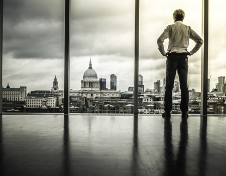 a person watching the view over the city from a highrise window